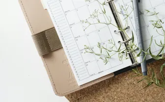 A pen resting on an open calendar