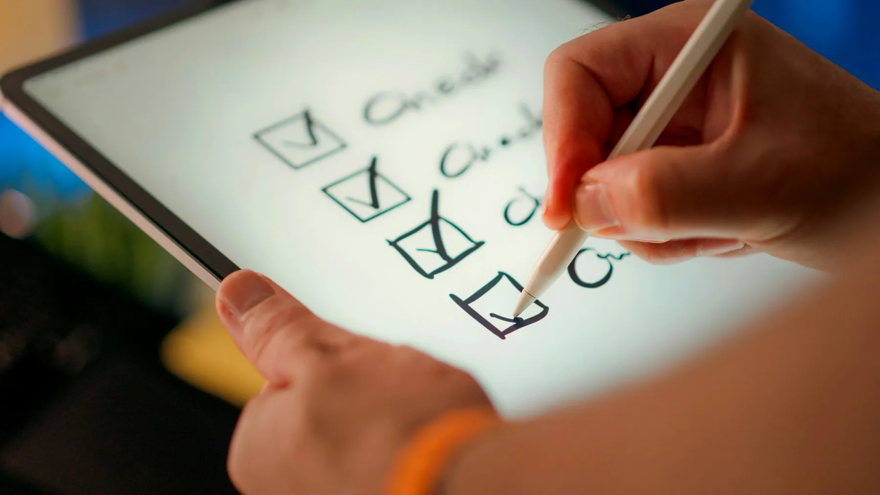 A hand marking off items on a checklist