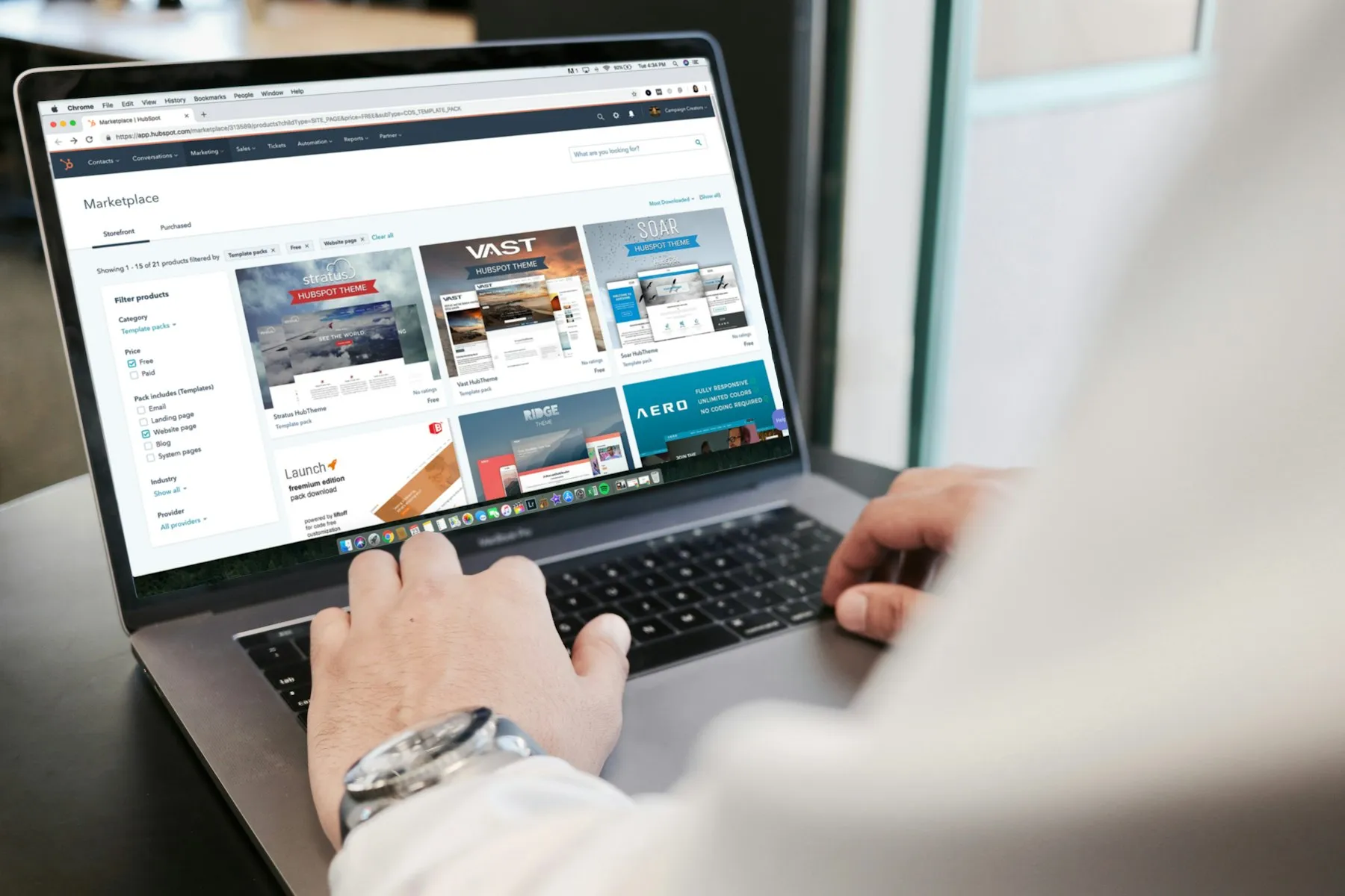 A person browsing a catalog on a laptop