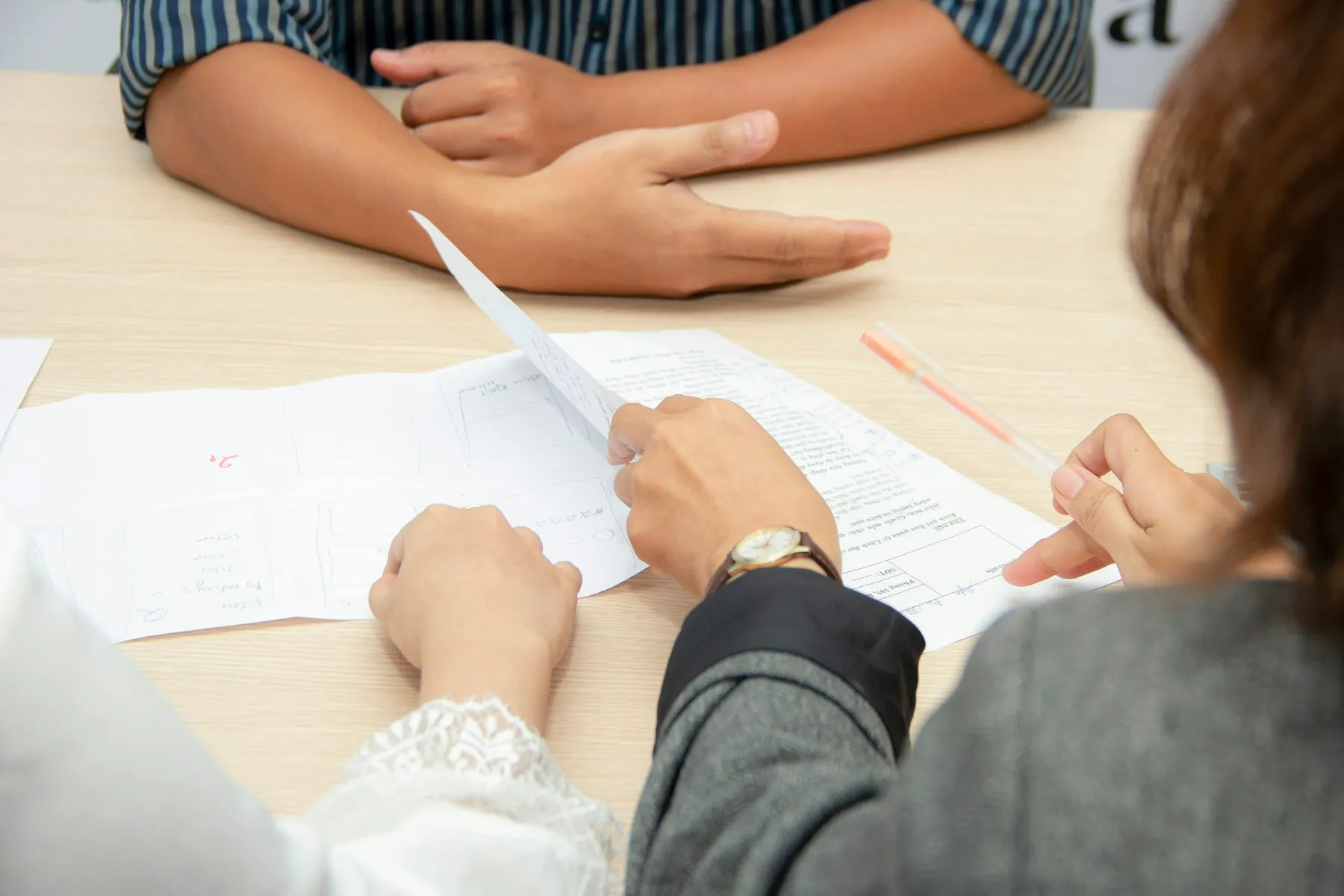 Two people reviewing documents at a table