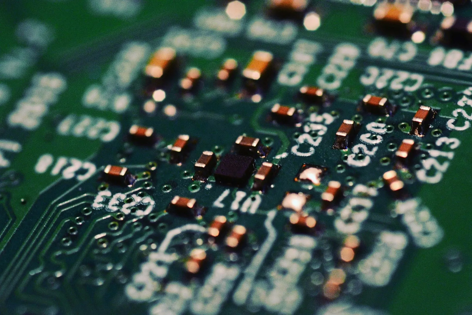 A close-up of a green circuit board with components