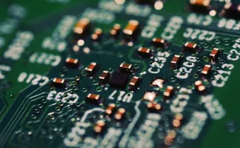 A close-up of a green circuit board with components