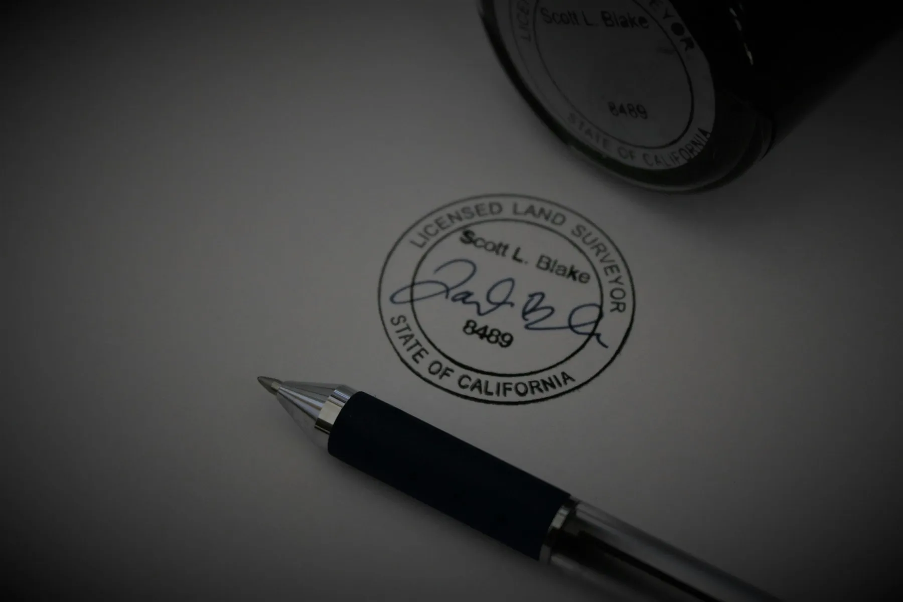 A pen resting on a printed standards document