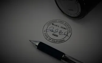 A pen resting on a printed standards document