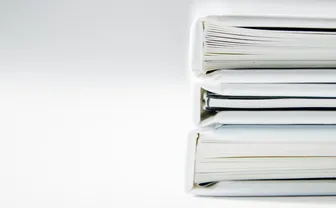 A stack of printed documents on a white surface