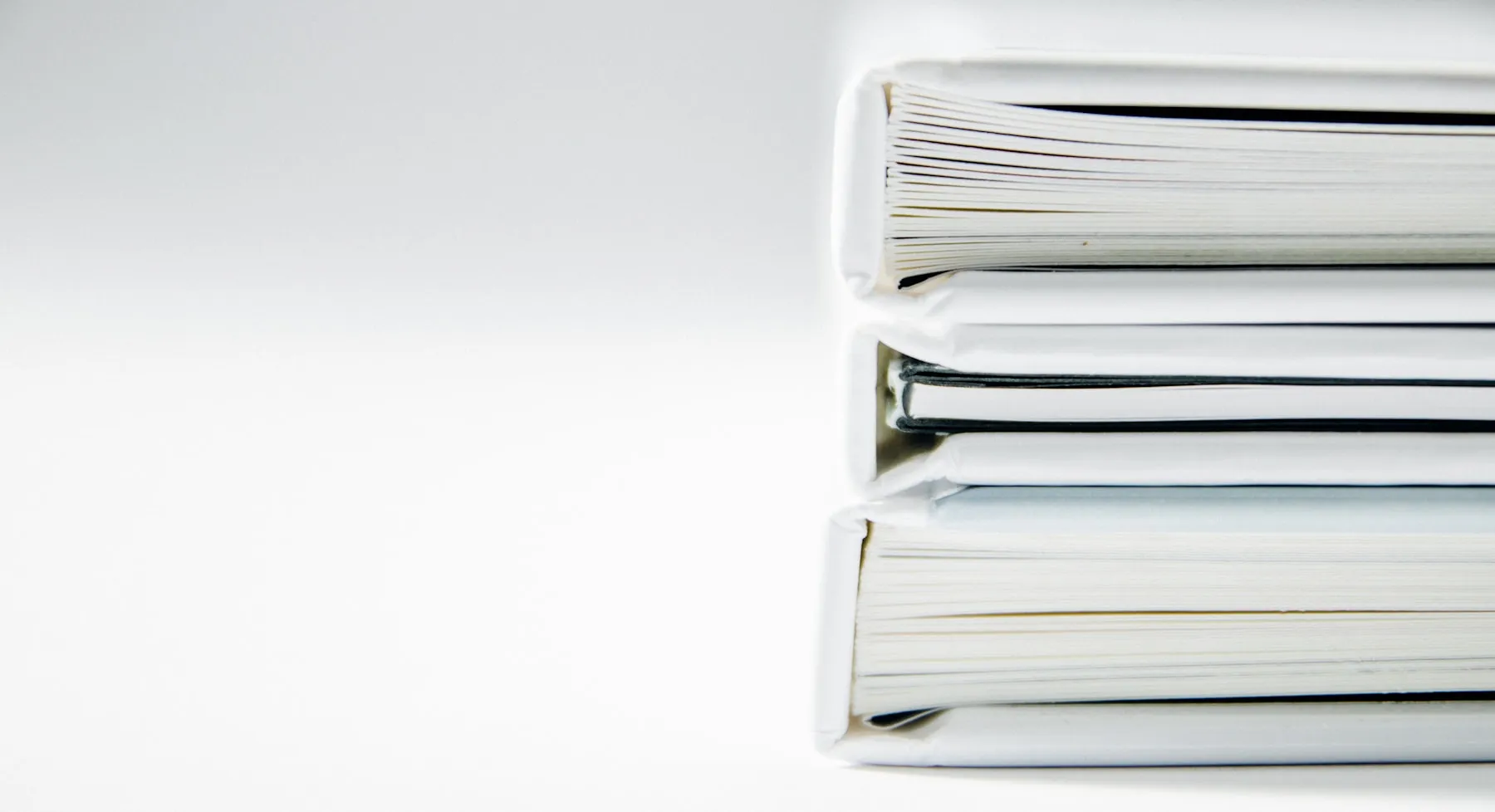 A stack of printed documents on a white surface