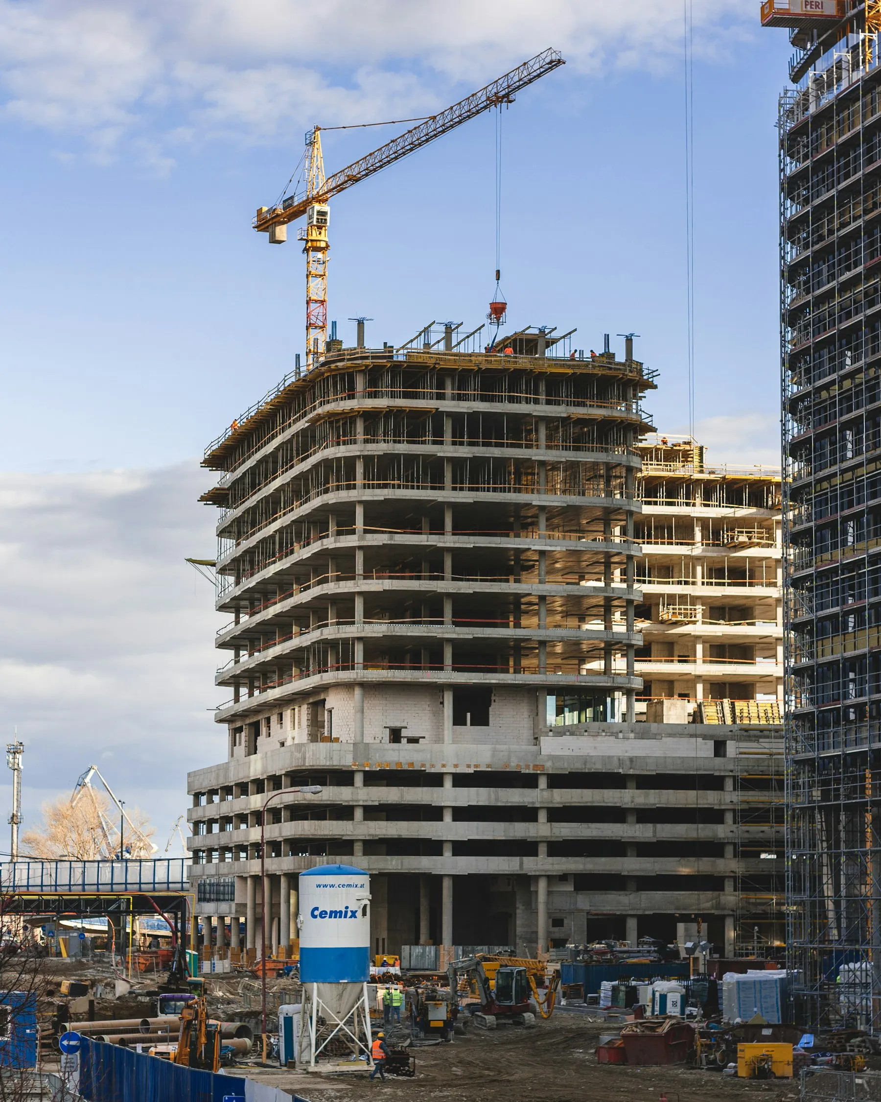 A high-rise building under construction with a crane