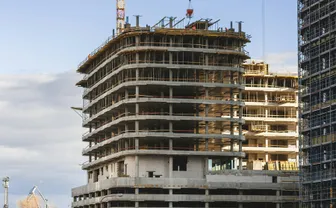A high-rise building under construction with a crane