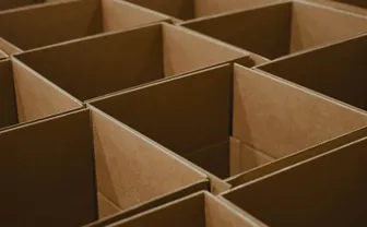 A grid of open corrugated cardboard boxes