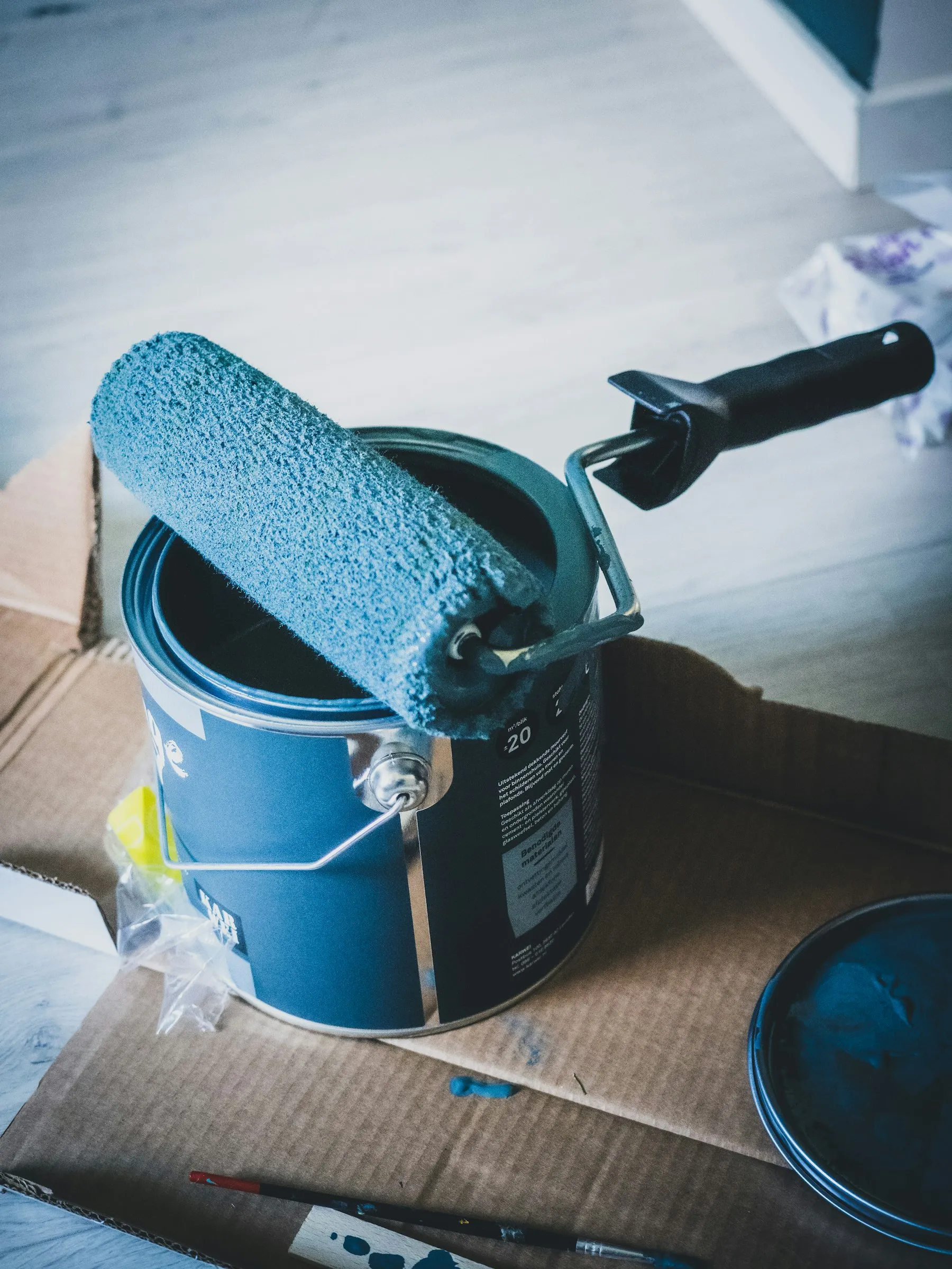 A paint can and roller on a table